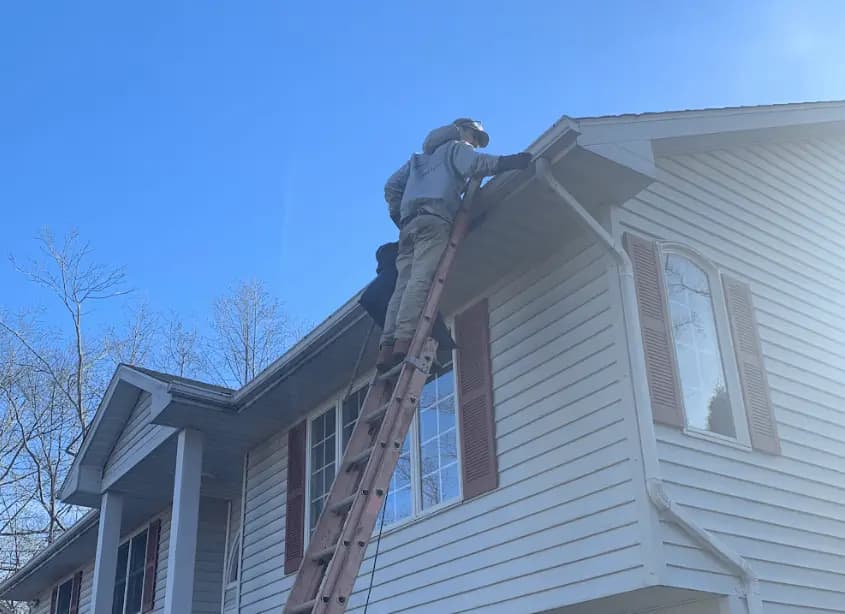 Gutter cleaning and maintenance being performed by Avon Power Washing in Avon